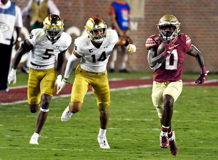 Sep 5, 2021; Tallahassee, Florida, USA; Florida State Seminoles running back Jashaun Corbin (0) runs for a touchdown past Notre Dame Fighting Irish safety Kyle Hamilton (14) and cornerback Cam Hart (5) during the first quarter at Doak S. Campbell Stadium. Mandatory Credit: Melina Myers-USA TODAY Sports